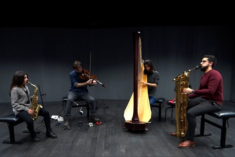 Slide Ensemble on stage at Toni-Areal: saxophone, violin, harp and baritone saxophone