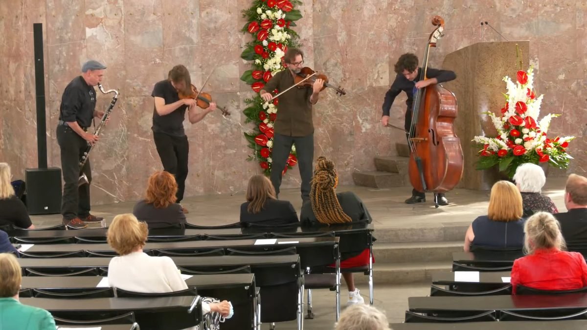 Quartet of improvisers playing in the Paulskirche in Frankfurt, audience in the foreground