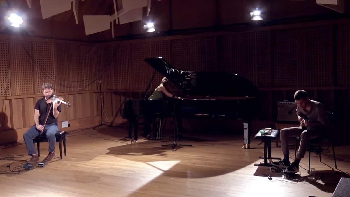 The trio seen across the hall: violin, piano and electric guitar