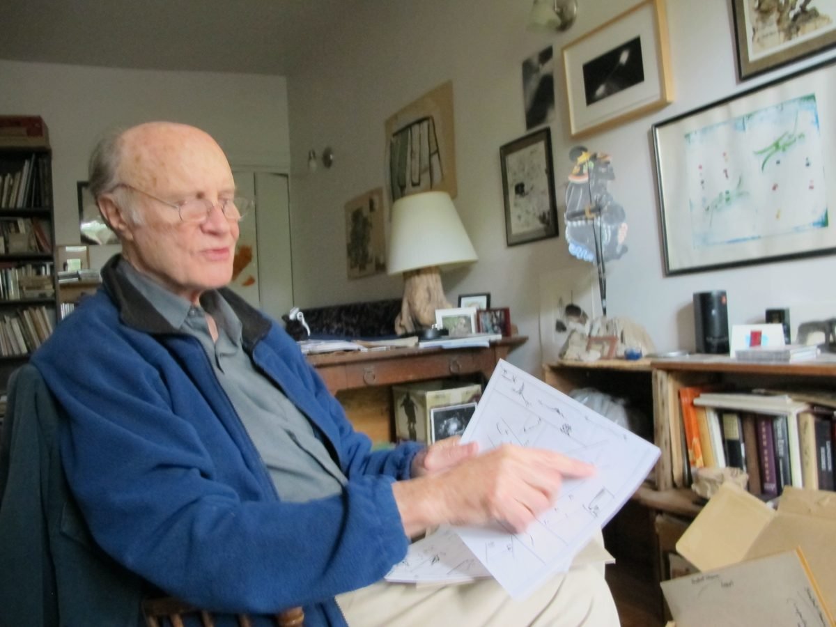 Malcolm Goldstein in his study, pointing at a score