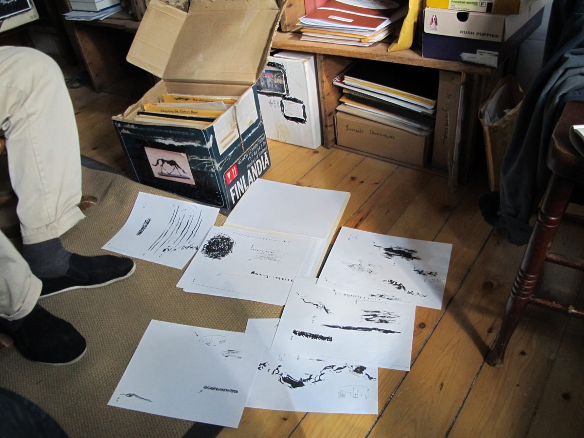 Graphic scores by Malcolm Goldstein spread on the wooden floor